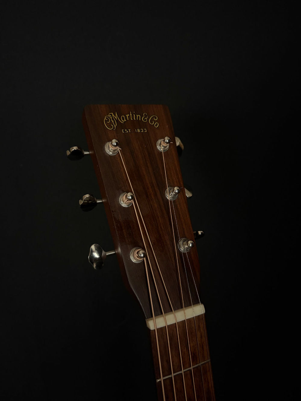 2011 Martin 00015M acoustic guitar headstock with "martin & co" logo