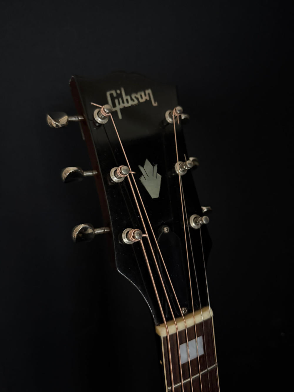 Circa 1971 Gibson SJ Deluxe acoustic guitar headstock with classic Gibson logo.