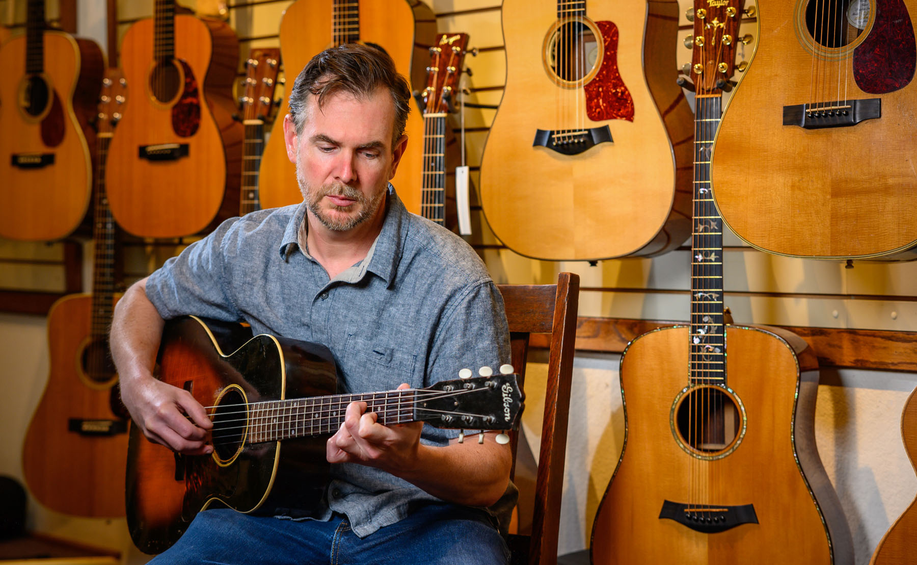 Man playing guitar in Acoustic Corner Asheville and Black Mountain