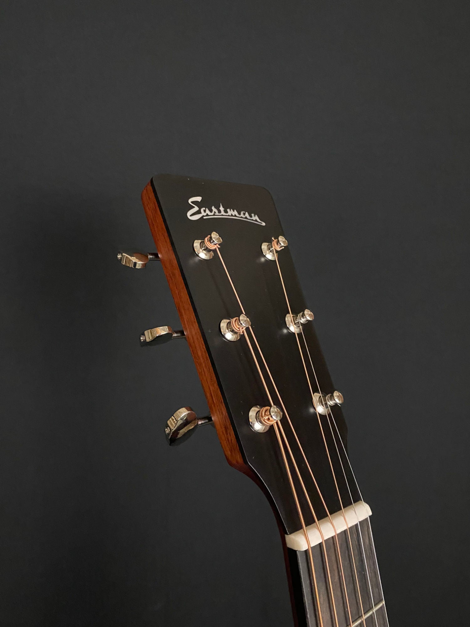 headstock of Eastman E2D Dreadnought cedar top acoustic guitar