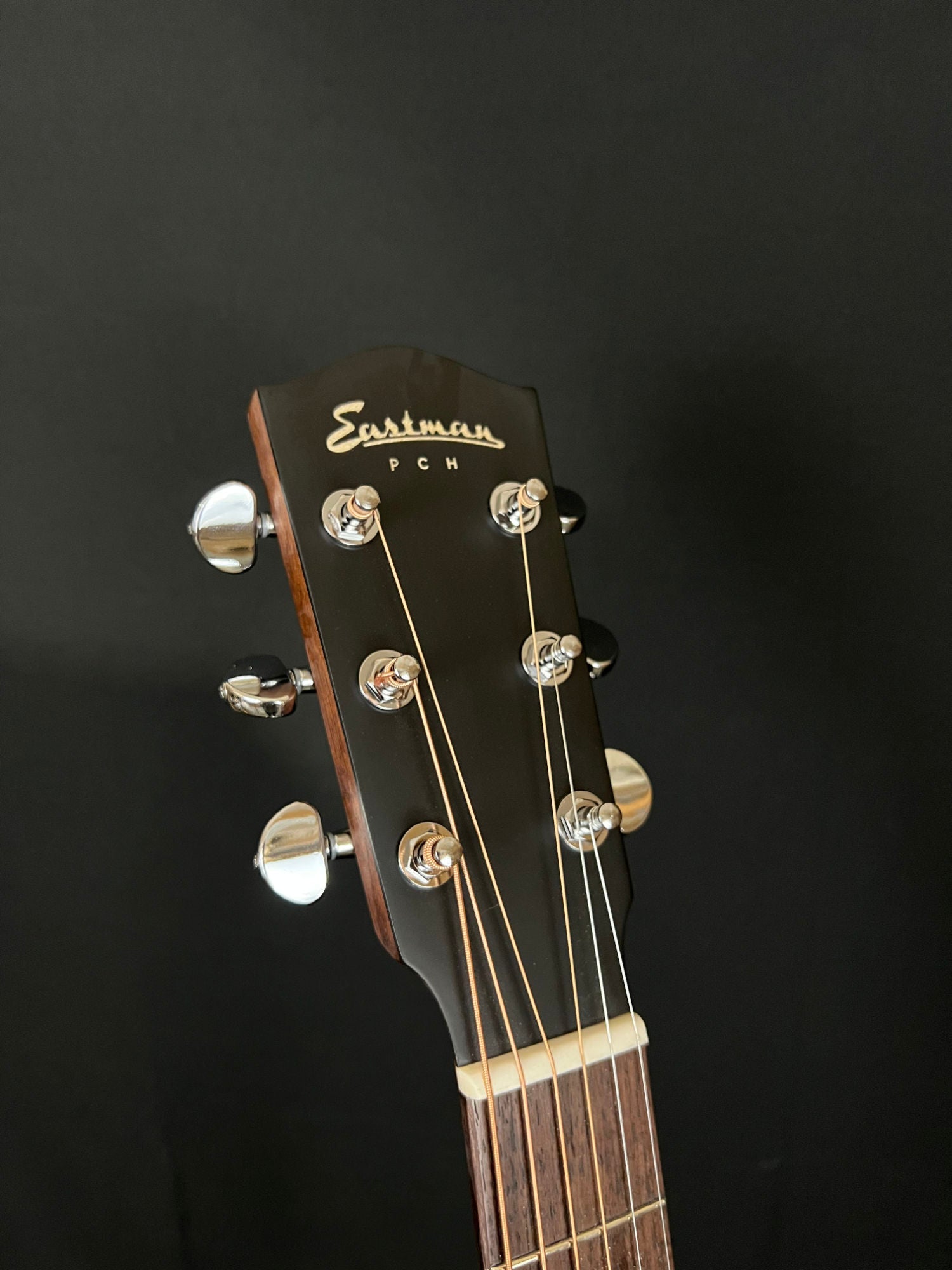 closeup of Eastman PCH2-GACE acoustic electric guitar headstock